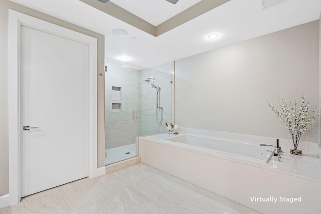 bathroom featuring separate shower and tub