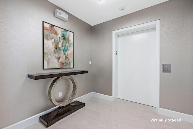 interior space with elevator and light tile patterned floors