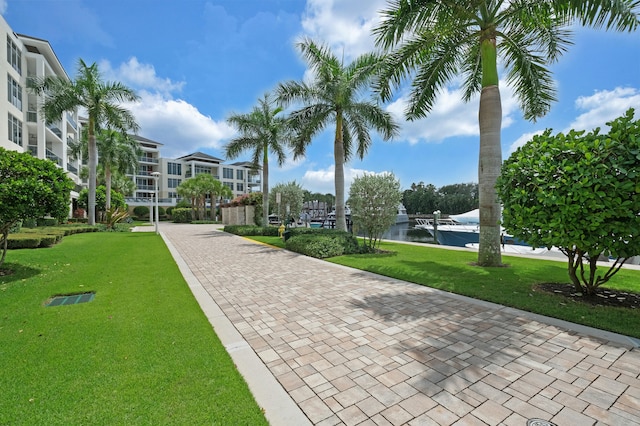 view of community featuring a water view and a lawn