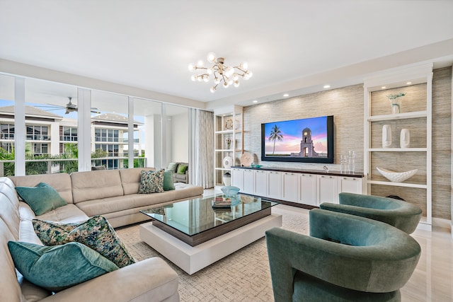 living room with ceiling fan with notable chandelier