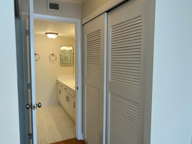 bathroom with tile patterned floors and vanity