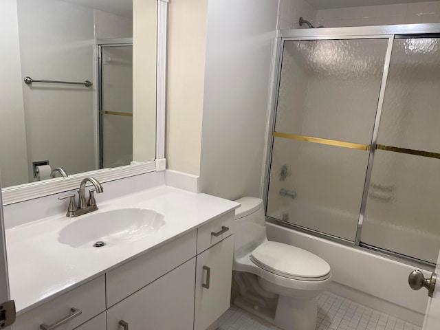 full bathroom with toilet, vanity, tile patterned floors, and combined bath / shower with glass door