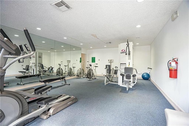 workout area with a textured ceiling