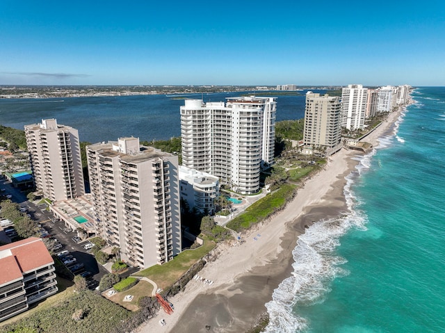 bird's eye view featuring a water view and a beach view