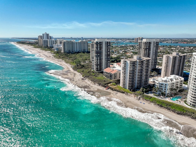 drone / aerial view featuring a beach view and a water view