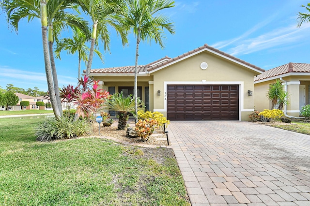 view of front of home with a front yard and a garage