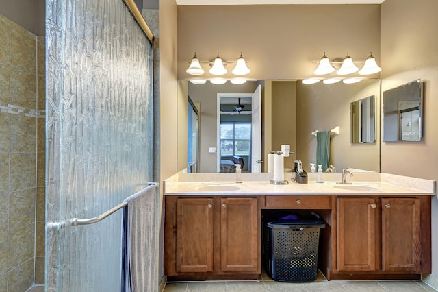 bathroom with tile patterned floors, ceiling fan, vanity, and walk in shower