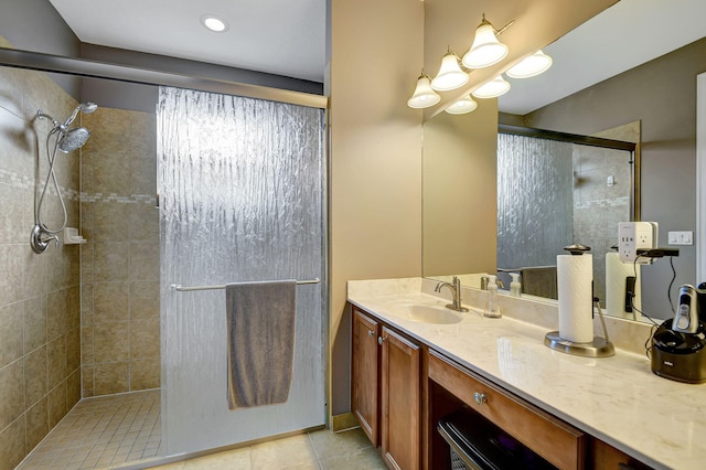 bathroom featuring tile patterned flooring, vanity, and an enclosed shower