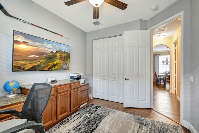 office featuring dark hardwood / wood-style floors and ceiling fan