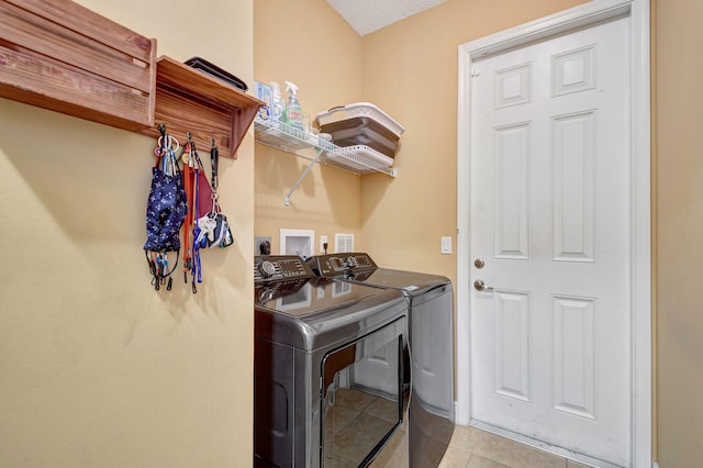 laundry room featuring light tile patterned floors and washer and clothes dryer