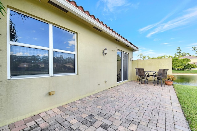 view of patio featuring a water view