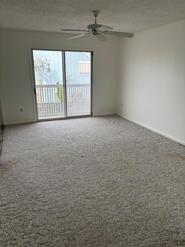 unfurnished room featuring carpet flooring, ceiling fan, and a textured ceiling