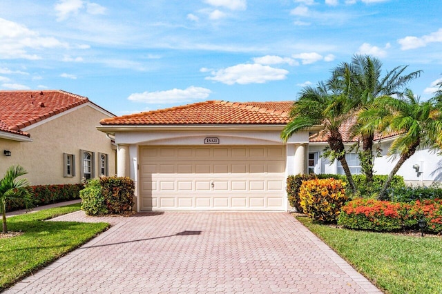 15321 Lake Wildflower Rd, Delray Beach, FL 33484 - mediterranean / spanish house with an attached garage, decorative driveway, and stucco siding
