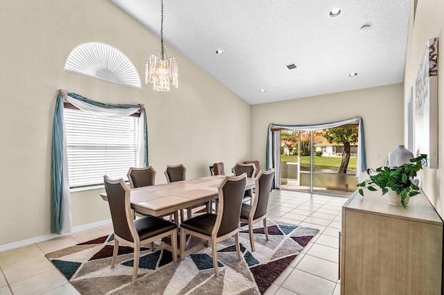 tiled dining area featuring high vaulted ceiling, a textured ceiling, and an inviting chandelier