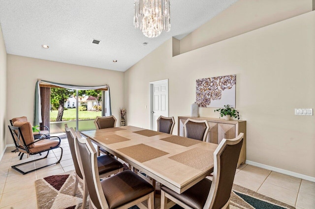 dining area featuring light tile patterned floors, a textured ceiling, and high vaulted ceiling