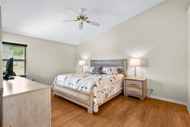 bedroom featuring a textured ceiling, light wood-type flooring, and ceiling fan