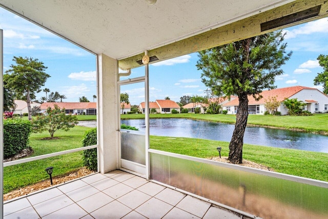 unfurnished sunroom featuring a water view