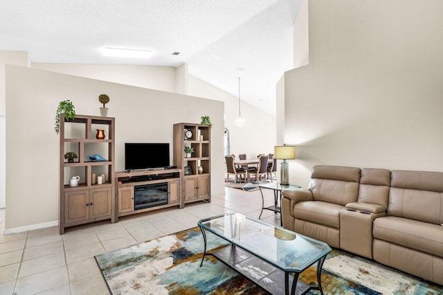 living room with a textured ceiling, light tile patterned flooring, and vaulted ceiling