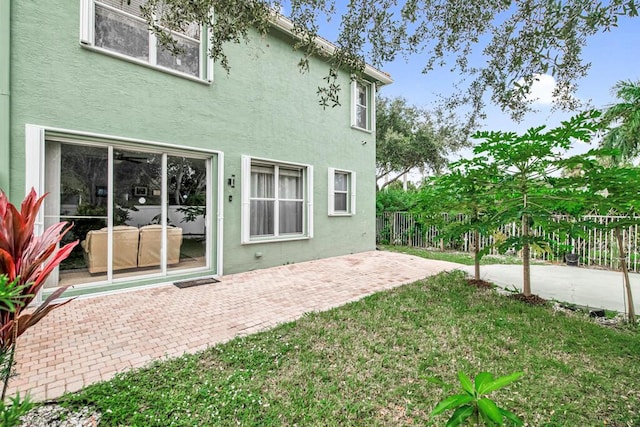 back of house with a yard and a patio