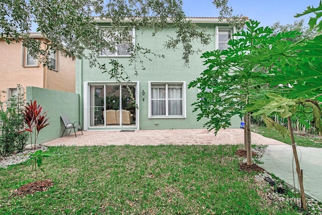 596 Calamint Pt, Royal Palm Beach, FL 33411 - back of property featuring fence, a patio area, a lawn, and stucco siding