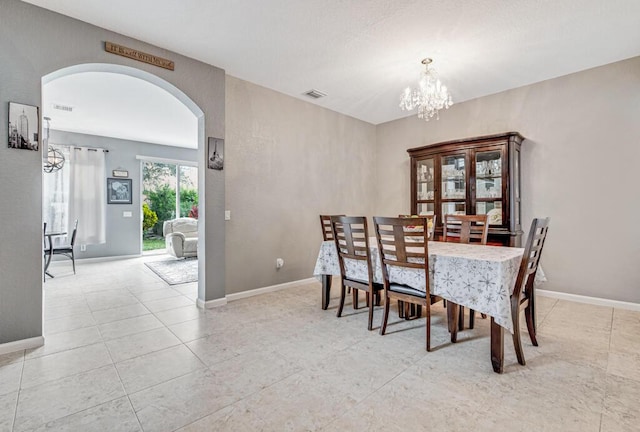 dining area featuring a notable chandelier