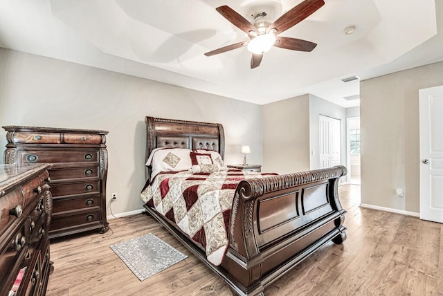 bedroom featuring a closet, light hardwood / wood-style floors, and ceiling fan