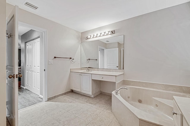 bathroom with a tub and vanity