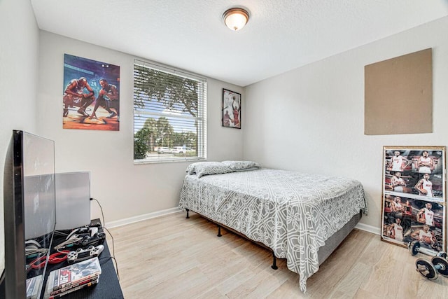 596 Calamint Pt, Royal Palm Beach, FL 33411 - bedroom with light wood finished floors, baseboards, and a textured ceiling