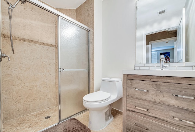 bathroom featuring tile patterned floors, vanity, toilet, and walk in shower