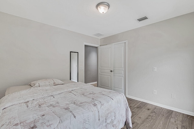 bedroom featuring hardwood / wood-style flooring and a closet