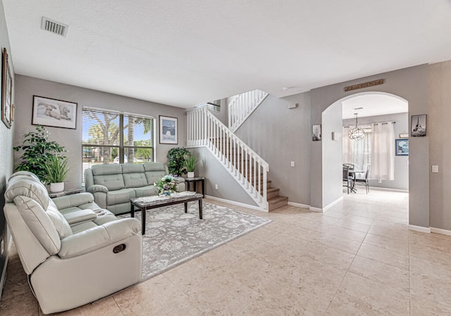 living room featuring a notable chandelier and light tile patterned flooring