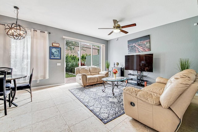 tiled living room with ceiling fan with notable chandelier