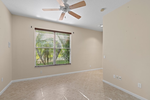 spare room featuring ceiling fan and a textured ceiling