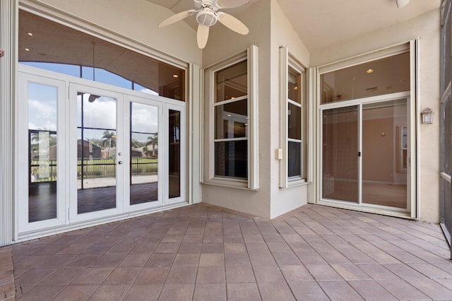 unfurnished sunroom with french doors, ceiling fan, and lofted ceiling