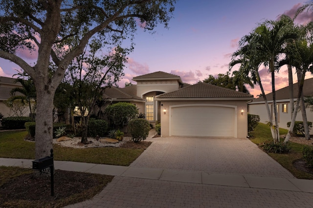 mediterranean / spanish-style home with a garage