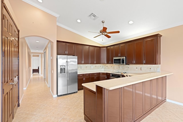 kitchen with kitchen peninsula, light tile patterned floors, ornamental molding, and appliances with stainless steel finishes