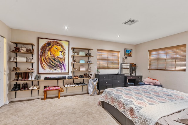 bedroom with tile patterned floors and multiple windows