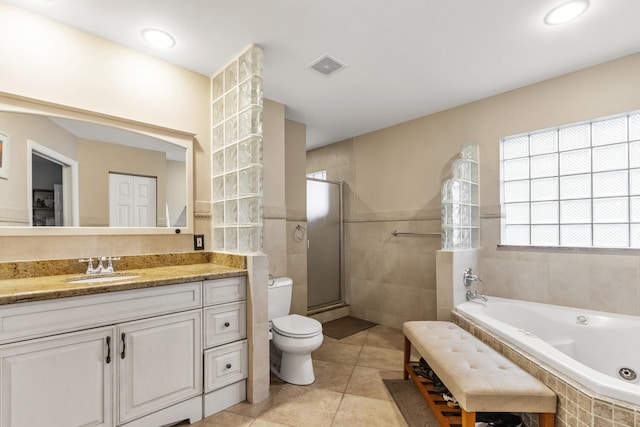 full bathroom with tile patterned floors, vanity, separate shower and tub, tile walls, and toilet