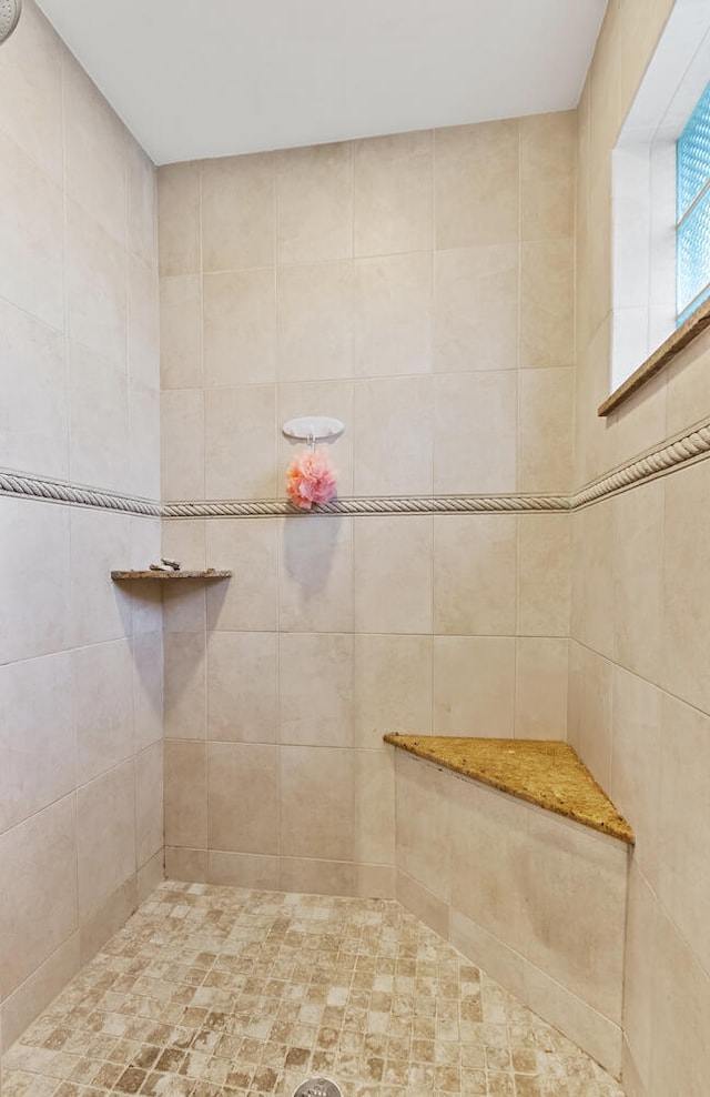 bathroom featuring tiled shower