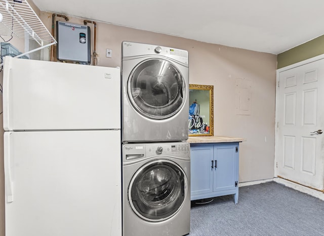 laundry room with cabinets, electric panel, stacked washer and dryer, and dark carpet