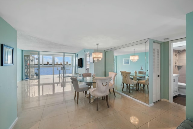 dining area featuring light tile patterned floors and an inviting chandelier