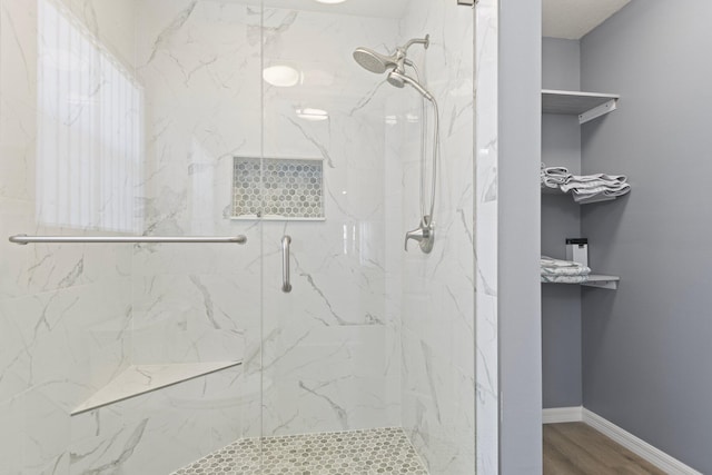 bathroom featuring hardwood / wood-style floors and walk in shower