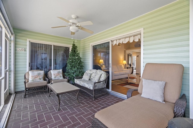 sunroom featuring ceiling fan