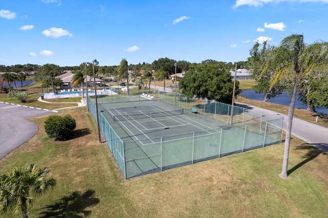 view of tennis court with a lawn