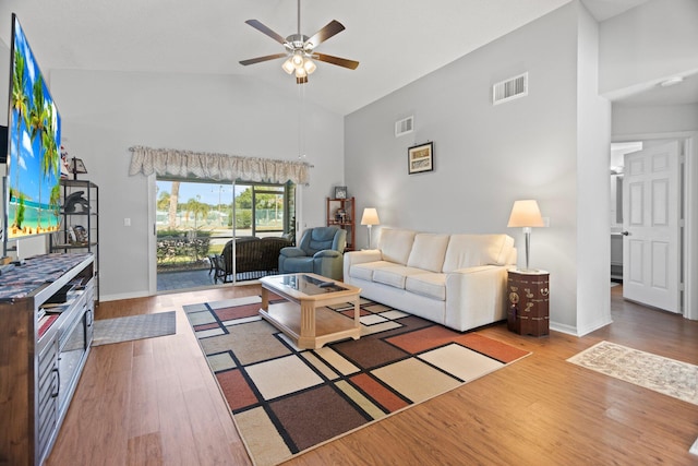 living room featuring ceiling fan, high vaulted ceiling, and hardwood / wood-style flooring