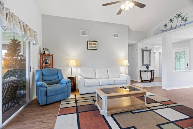 living room featuring ceiling fan, hardwood / wood-style floors, and high vaulted ceiling