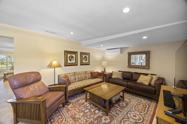 living room with tile patterned flooring, a textured ceiling, and a wall mounted air conditioner