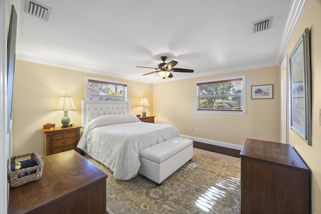 bedroom featuring multiple windows, ceiling fan, and crown molding