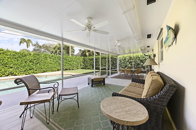 sunroom with ceiling fan and plenty of natural light