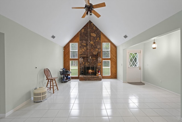 unfurnished living room with a fireplace, high vaulted ceiling, ceiling fan, and light tile patterned flooring